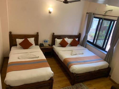 Ein Bett oder Betten in einem Zimmer der Unterkunft Hotel Ramanam
