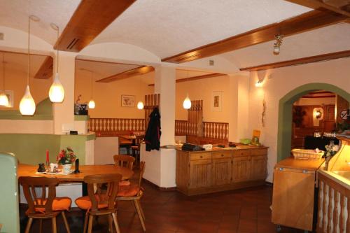 a kitchen with a table and chairs and a counter at Pension Göschlberger in Mondsee