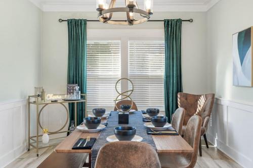 a dining room with a table with chairs and a chandelier at Emerald-Gem-Inn • Laguna Haven/Beach Home! in Panama City Beach
