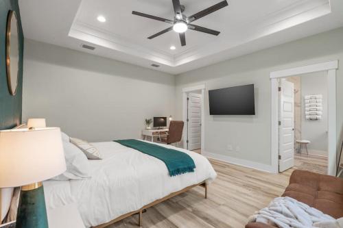 a bedroom with a bed and a flat screen tv at Emerald-Gem-Inn • Laguna Haven/Beach Home! in Panama City Beach