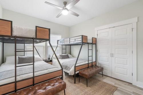 a bedroom with three bunk beds and a ceiling fan at Emerald-Gem-Inn • Laguna Haven/Beach Home! in Panama City Beach