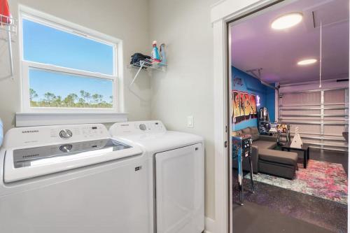 a kitchen with a stove and a living room at Emerald-Gem-Inn • Laguna Haven/Beach Home! in Panama City Beach