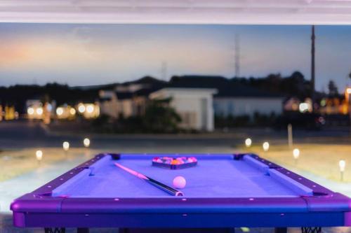 a purple pool table with balls and bats on it at Emerald-Gem-Inn • Laguna Haven/Beach Home! in Panama City Beach