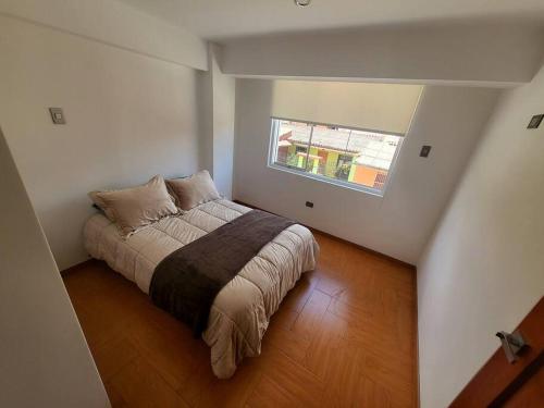 a bedroom with a bed in a room with a window at Aurora Guest House - Luxury Apartment in Huaraz