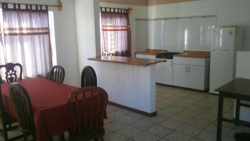 a kitchen with a table and a kitchen with a refrigerator at DEPARTAMENTOS AMUEBLADOS CELIA in Morelia