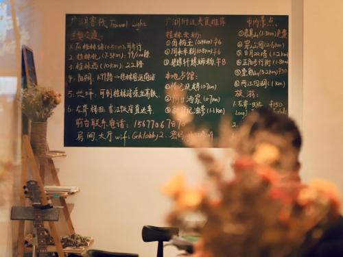 a chalkboard with asian writing on a wall at Travel light Guilin in Guilin