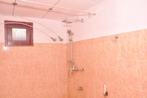 a bathroom with a shower with a window at Himashi Sea View Homestay in Gandara East