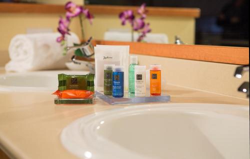 a bathroom sink with toothbrushes and other products on it at Radisson Hotel Portland Airport in Portland