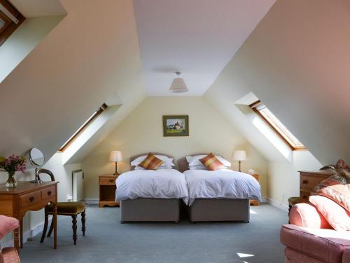 a bedroom with a large bed in a attic at Broad Cottage Boathouse in Ranworth