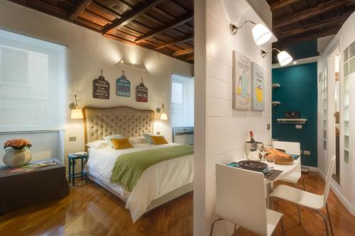 a bedroom with a bed and a desk in a room at RomEnjoy Colosseo in Rome