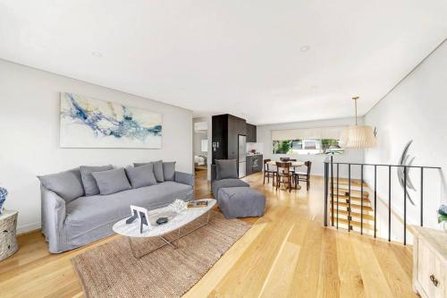 a living room with a couch and a table at Sea and Salt Hyams Beach in Hyams Beach