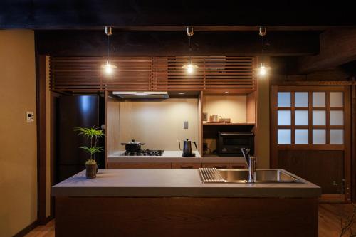 a kitchen with a sink and a refrigerator at 八百熊川 Yao-Kumagawa in Kumagawa
