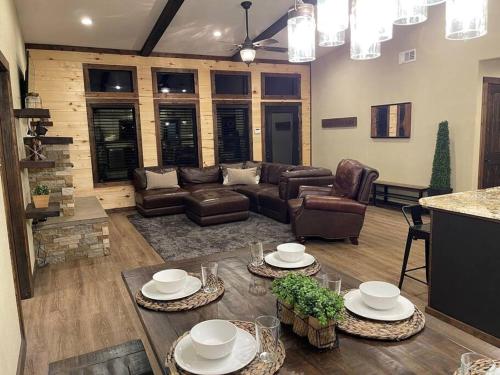 a living room with a couch and a table at Bent Tree Cabin, on Private 12.5 Acres + Hot Tub in Broken Bow