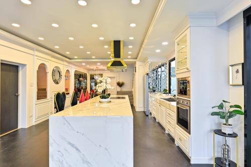 a kitchen with a white counter and a large island at 4BD Pool Villa Pattaya with Jacuzzi - Exquisite Pool Villa A in Pattaya South