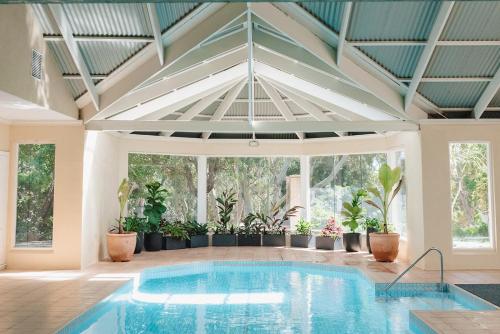a swimming pool in a house with a ceiling at The Retreat at Stirling in Stirling