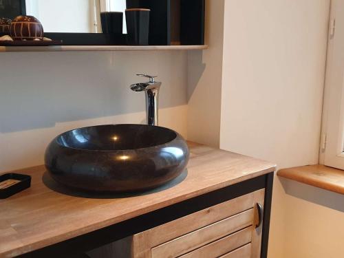 La salle de bains est pourvue d'un grand évier en pierre sur un comptoir. dans l'établissement Maison en pierre 3* rénovée, jardin, WIFI, proche plage et commerces, Ploumanac'h - FR-1-368-87, à Perros-Guirec