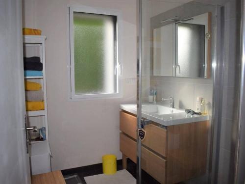 ein Bad mit einem Waschbecken und einem Spiegel in der Unterkunft Maison Pleumeur-Bodou, 6 pièces, 10 personnes - FR-1-368-129 in Pleumeur-Bodou