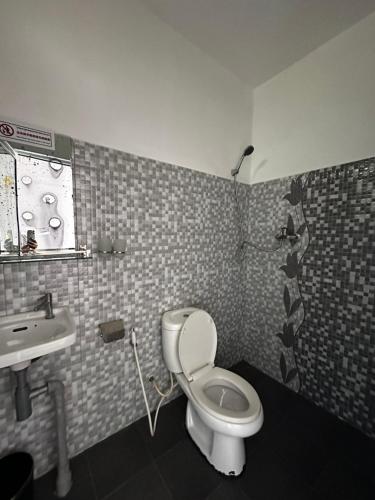 a bathroom with a toilet and a sink at Ginger Sihanoukville in Sihanoukville