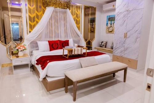 a bedroom with a large bed with a canopy at Exquisite Pool Villa J - Pattaya Pool Villa in Pattaya South