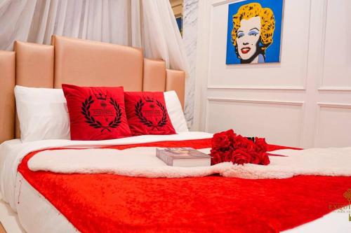 a bed with red pillows and a red blanket at Exquisite Pool Villa J - Pattaya Pool Villa in Pattaya South