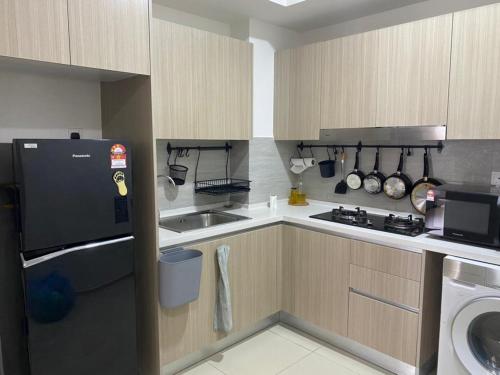 a small kitchen with a sink and a stove at Wallaway2stay Gravit8 Klang 2Room in Klang