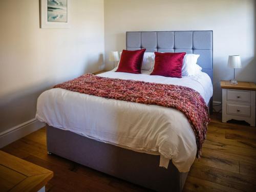 a bedroom with a large bed with red pillows at The Tower in Johnston