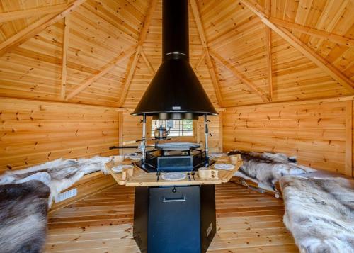 a kitchen in a log cabin with a stove at Gadgirth Estate Lodges in Annbank