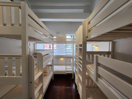 a row of bunk beds in a prison cell at BEAT Arts Hostel at Chinatown in Singapore