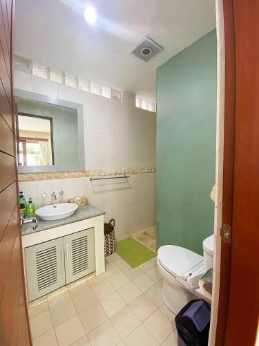 a bathroom with a toilet and a sink at Villa Mudha 3 Sanur in Sanur