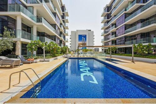 a swimming pool in the middle of a building at Bright and spacious apartment in DAMAC HILLS in Dubai