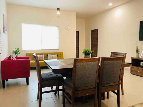a living room with a dining room table and chairs at CASA LUNA , para 6 personas in La Paz