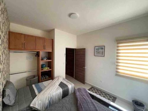 a small bedroom with a bed and a window at CASA LUNA , para 6 personas in La Paz