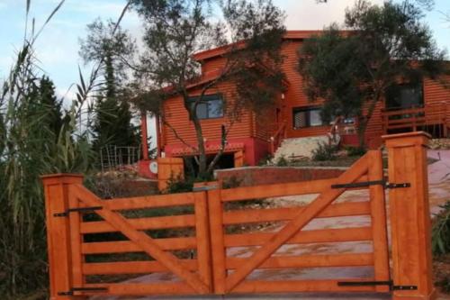 a wooden fence in front of a house at The lodge in Mesongi