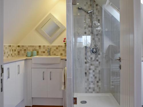 a bathroom with a shower and a sink at Kingshill Farm - Meadow View in Little Missenden