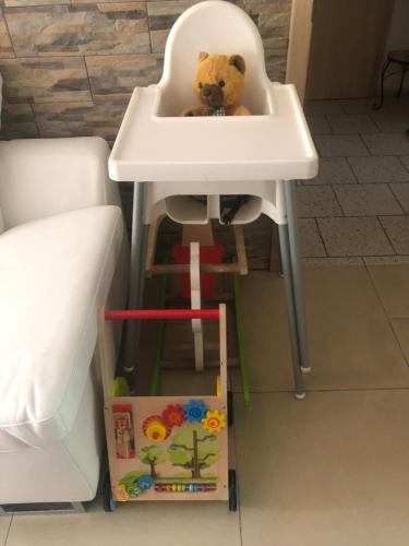 a teddy bear sitting in a high chair in a sink at Ubytování U draka in Třeboň