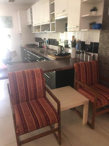 a kitchen with two chairs and a table and a counter at Ubytování U draka in Třeboň