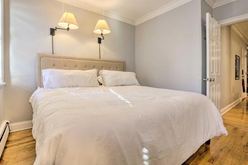 a bedroom with a large white bed with two pillows at Hoboken Condo Walk to Public Transit! in Hoboken