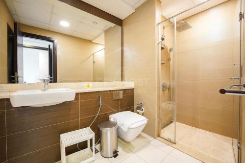 a bathroom with a toilet and a sink and a shower at KeyHost - Elegant 1BR at Sparkle Tower Dubai Marina - K2630 in Dubai