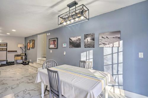 a dining room with blue walls and a table and chairs at Pet-Friendly Clearfield Home Near Hill AFB! in Clearfield