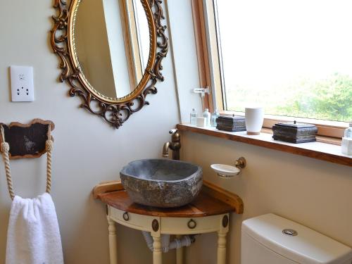a bathroom with a sink and a mirror on the wall at Broomhouse Lodge in Edrom