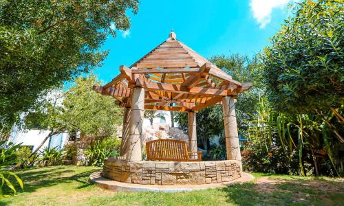 a wooden gazebo with a bench in a yard at Dubai Marine Beach Resort & Spa in Dubai