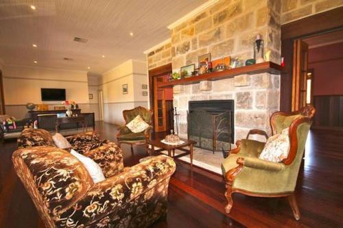 a living room with a couch and a fireplace at Hanging Tree Wines in Pokolbin