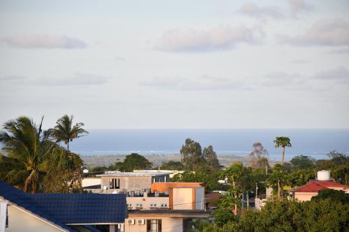 a view of a city with palm trees and buildings at Seaview Resort in Brisée Verdière