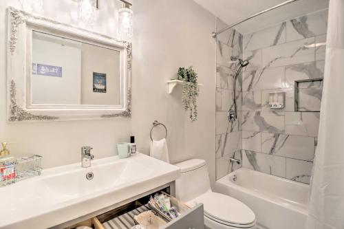 a bathroom with a sink and a toilet and a shower at Gas Grill, Lake Access Scenic Poconos Retreat! in East Stroudsburg