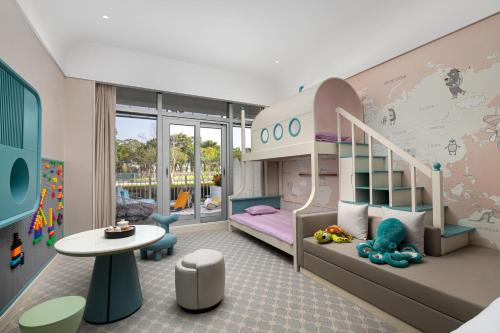 a childs room with a bunk bed and a table at Xiamen International Seaside Hotel -Hotel corridor leads to the stone exhibition hall in Xiamen