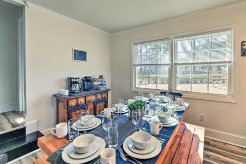 a dining room with a table with dishes on it at Family-Friendly New Bern Home with Backyard! in New Bern