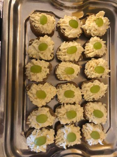 a tray of cookies with green eyes on them at Ubytování U draka in Třeboň