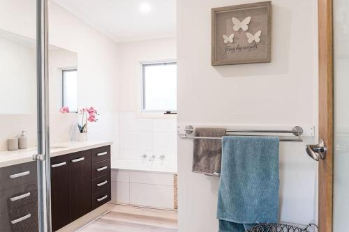 a bathroom with a sink and a shower backdoor at Blairgowrie Whitesands - stay 3 nights for FREE WINE in Blairgowrie