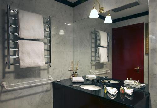 a bathroom with a sink and a mirror at Sullivans Cove Apartments in Hobart
