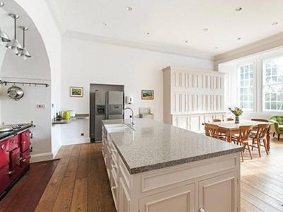 a large kitchen with a counter top and a table at Hockwold Hall in Hockwold cum Wilton